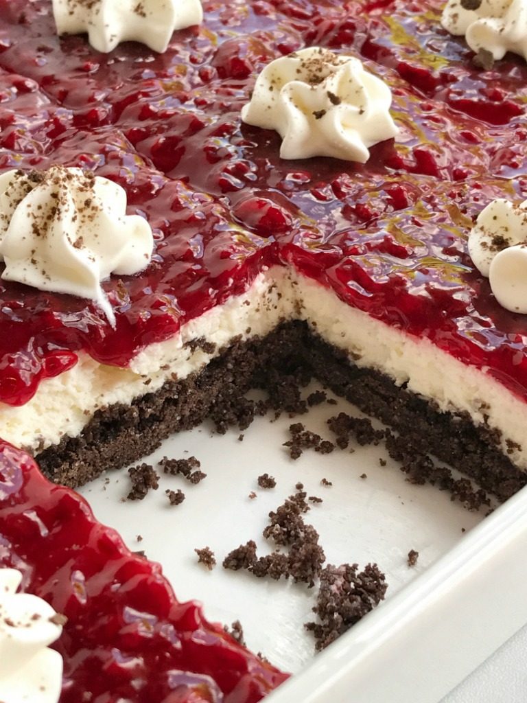 Chocolate raspberry cheesecake delight is an almost no-bake dessert with three delicious layers! A chocolate graham cracker crust, creamy sweet cheesecake middle, and topped with raspberry pie filling. 