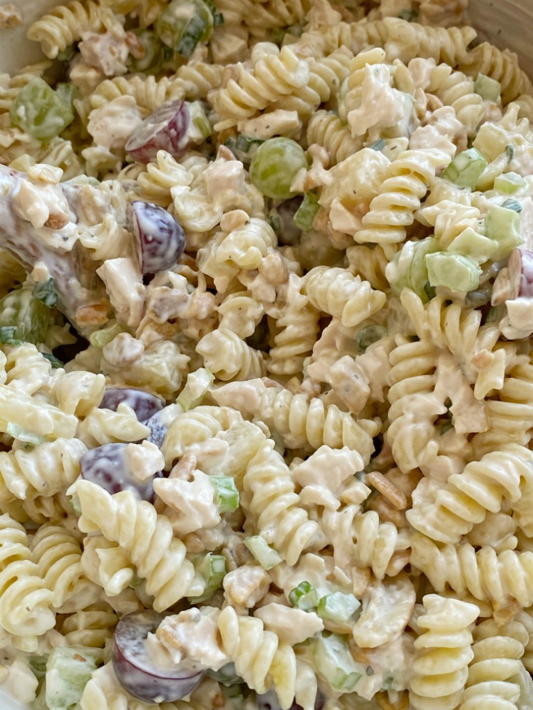 Cashew Chicken Pasta Salad is a creamy pasta salad recipe that's full of texture and flavor. Grapes, pineapple tidbits, celery, green onion, cashews, and chicken in a creamy ranch dressing sauce and spiral pasta noodles. 