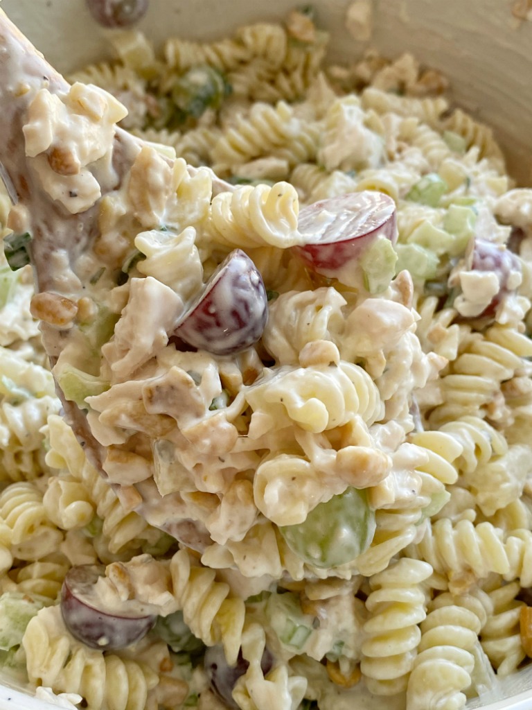 Cashew Chicken Pasta Salad is a creamy pasta salad recipe that's full of texture and flavor. Grapes, pineapple tidbits, celery, green onion, cashews, and chicken in a creamy ranch dressing sauce and spiral pasta noodles. 