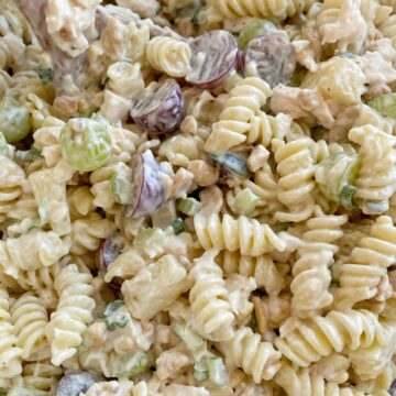 Cashew Chicken Pasta Salad is a creamy pasta salad recipe that's full of texture and flavor. Grapes, pineapple tidbits, celery, green onion, cashews, and chicken in a creamy ranch dressing sauce and spiral pasta noodles. 