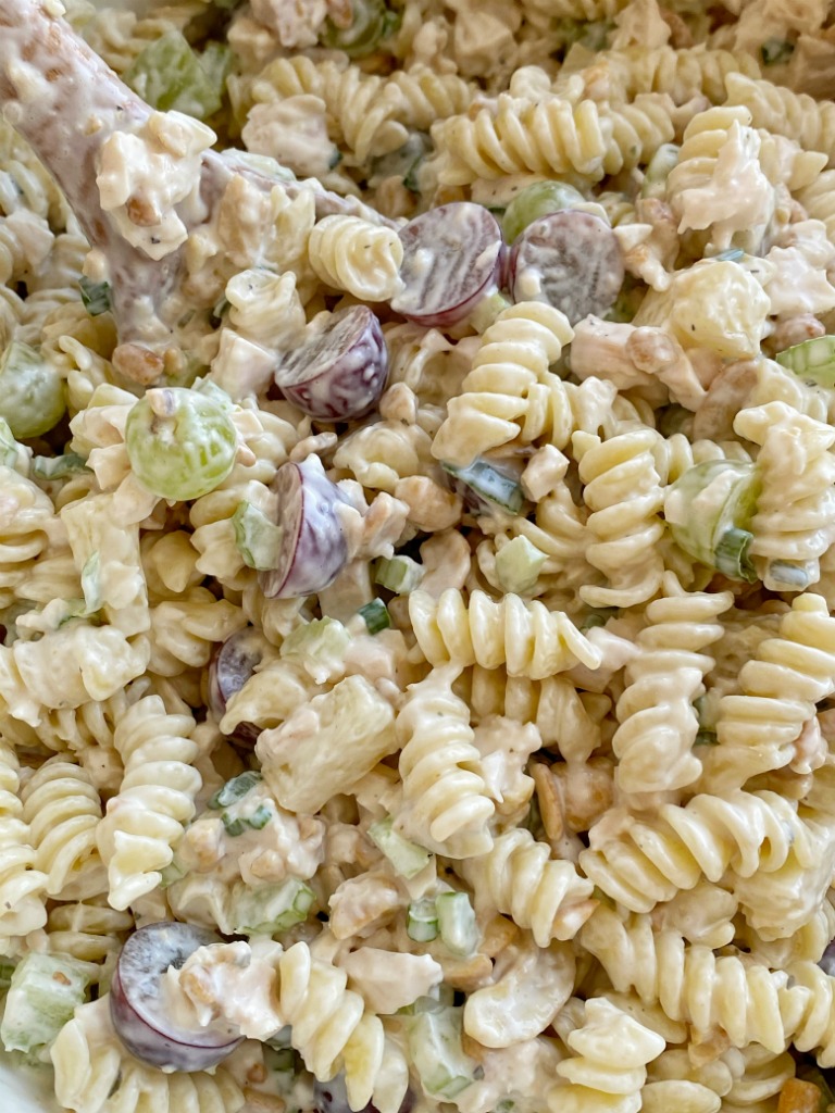 Cashew Chicken Pasta Salad is a creamy pasta salad recipe that's full of texture and flavor. Grapes, pineapple tidbits, celery, green onion, cashews, and chicken in a creamy ranch dressing sauce and spiral pasta noodles. 