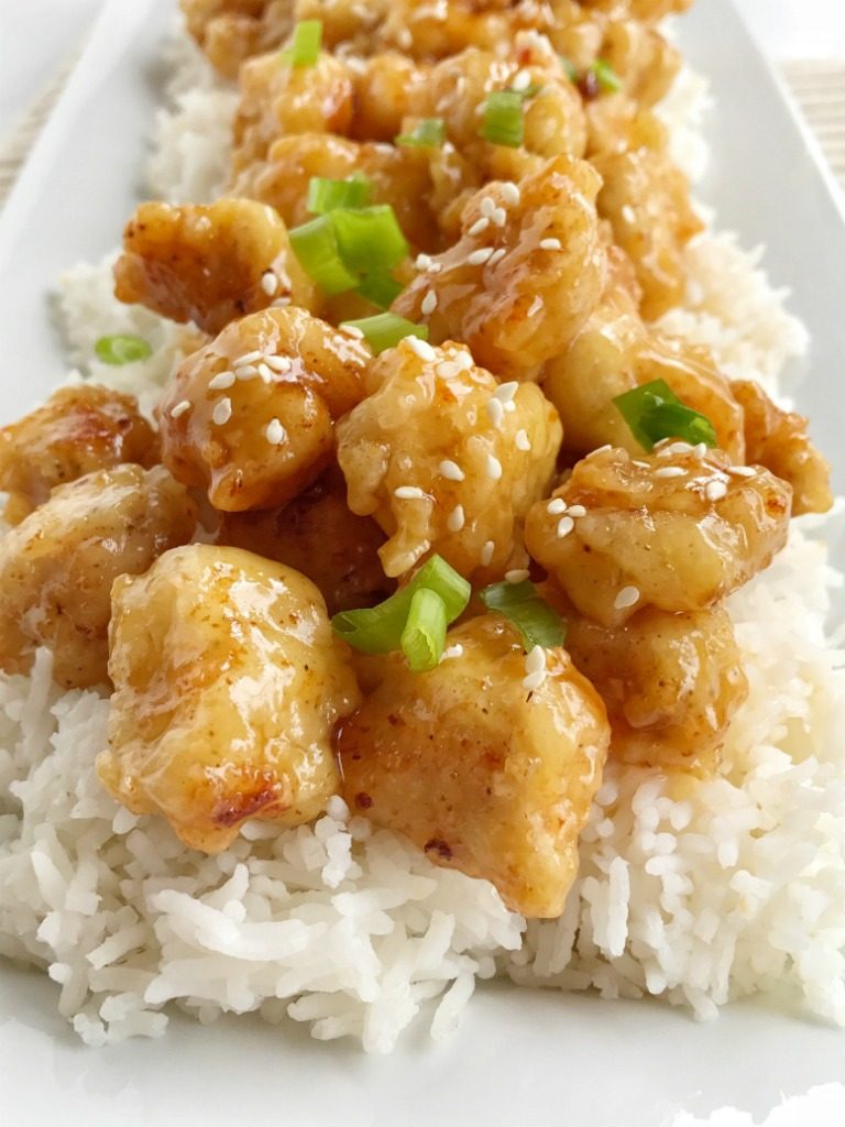 Crispy Asian honey chicken is tender chunks of chicken breaded with a crispy coating and pan fried. Whip up a quick & simple Asian honey sauce and drizzle over the crispy chicken. Serve with rice and you have a completely delicious dinner that will be better than any take-out.