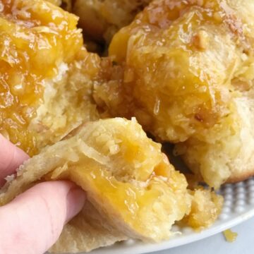 This easy, no yeast needed tropical monkey bread is loaded with Hawaiian flavors! Flaky, buttery rolls covered in coconut pudding, macadamia nuts, coconut, sugar, and pineapple. Prepare the night before for easy overnight sweet bread in the morning. This stuff is so delicious and makes for a great dessert or extra special breakfast.