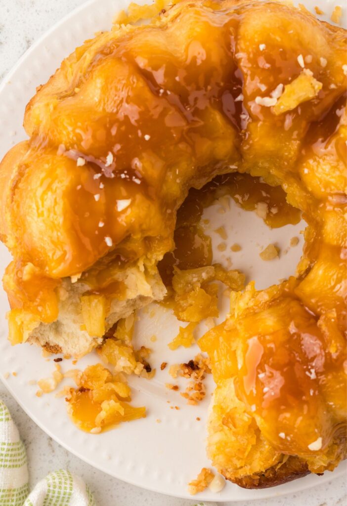 The monkey bread with pieces pulled out of it