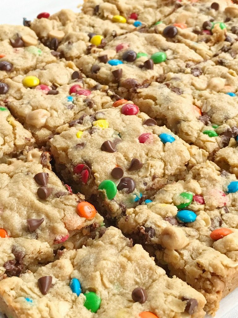 Monster cookie bars are a fun treat loaded with peanut butter, oats, chocolate chips, peanut butter chips, and mini m&m's. They bake up perfectly soft, chewy, and thick. A fun treat to make with the kids or great for back-to-school lunches or after school treat. 