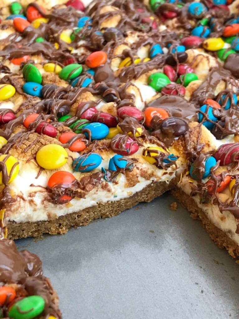   Four ingredients are all you need for this super easy, quick to make, and delicious peanut butter s'mores cookie bars! Get the kids involved and make this fun dessert in a matter of minutes. Tastes just like a toasty s'mores with peanut butter and chocolate candies | togetherasfamily.com