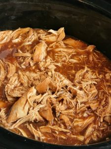 Root beer BBQ chicken sandwiches are so incredibly easy to make! 3 ingredients and a slow cooker are all you need for a delicious dinner that is ready when you are. Perfect for a busy weeknight, picnic, potluck, or BBQ. Root beer, chicken breasts, BBQ sauce, and a few spices are all you need.