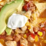 Skinny chicken taco soup only takes 30 minutes to have on the dinner table and it's all cooked in just one pot! Get a healthy, delicious, and comforting dinner on the table in record time and with hardly any dishes. The leftovers make a great lunch for the next day.