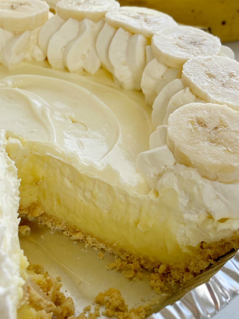 Banana Cream Pie has three layers of banana pudding, cheesecake, and cheesecake whipped topping inside a shortbread crust. This no bake pie takes just minutes to prepare and it's the best banana cream pie because it has no browned, mushy bananas in it!