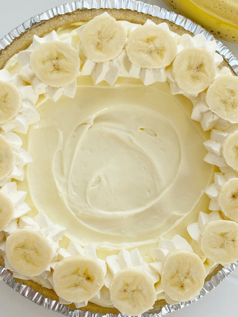 Banana Cream Pie has three layers of banana pudding, cheesecake, and cheesecake whipped topping inside a shortbread crust. This no bake pie takes just minutes to prepare and it's the best banana cream pie because it has no browned, mushy bananas in it!
