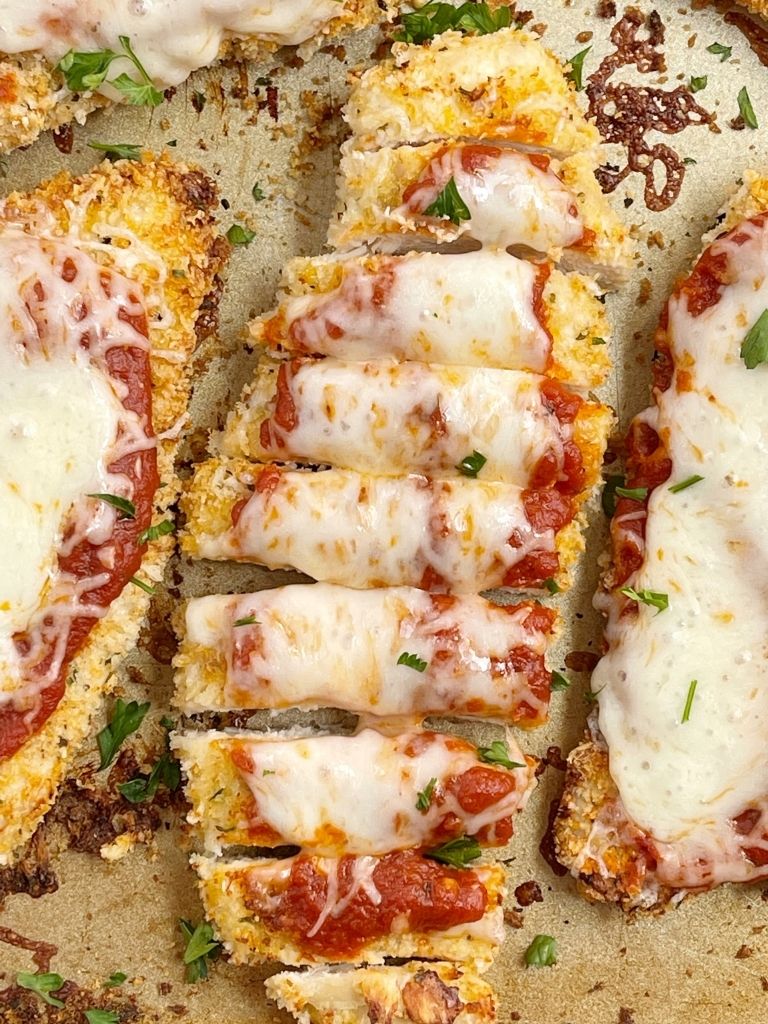 Baking sheet with parmesan chicken and cheese.
