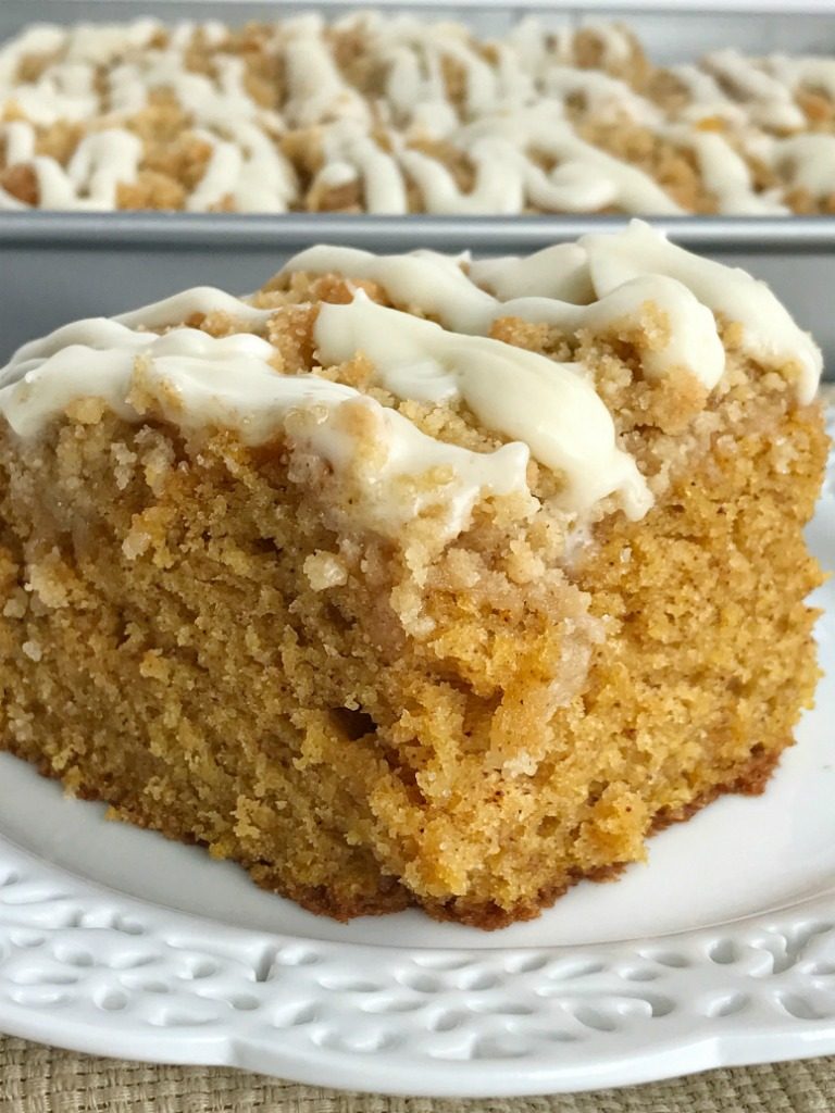 Moist and tender pumpkin cake loaded with warm pumpkin spices and topped with a sweet cinnamon & brown sugar streusel. Mix up a simple vanilla glaze to drizzle over the top. This streusel pumpkin cake is the best Fall pumpkin dessert recipe | www.togetherasfamily.com #pumpkinrecipes #pumpkin_recipes #pumpkincake