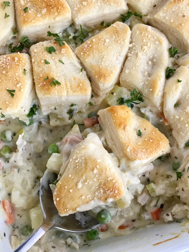 Creamy chicken pot pie casserole is the ultimate comfort food recipe. Vegetables and chicken simmer in a creamy chicken broth and then they're topped with flaky buttermilk biscuits. Creamy, warm, comforting, homemade goodness in one casserole pan | www.togetherasfamily.com #casserolerecipes #recipe #dinnerrecipes #chickenrecipes #chickencasserole #chicken #comfortfood
