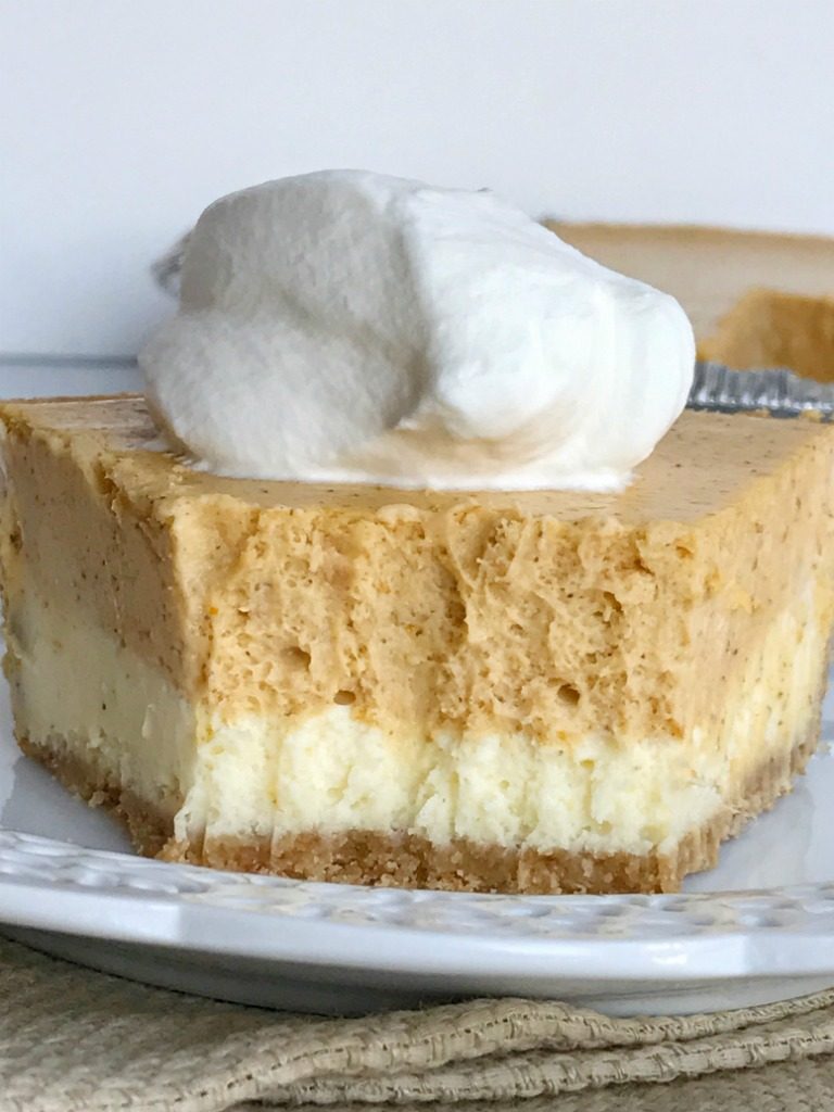 Double layer pumpkin cheesecake pie has two layers of pumpkin cheesecake inside a prepared graham cracker crust. This is an easy cheesecake recipe that even beginners can make. Top with some fresh whipped cream for the ultimate Fall dessert or add it to your Thanksgiving dessert table | www.togetherasfamily.com #pumpkin #pumpkinrecipes #cheesecakerecipes