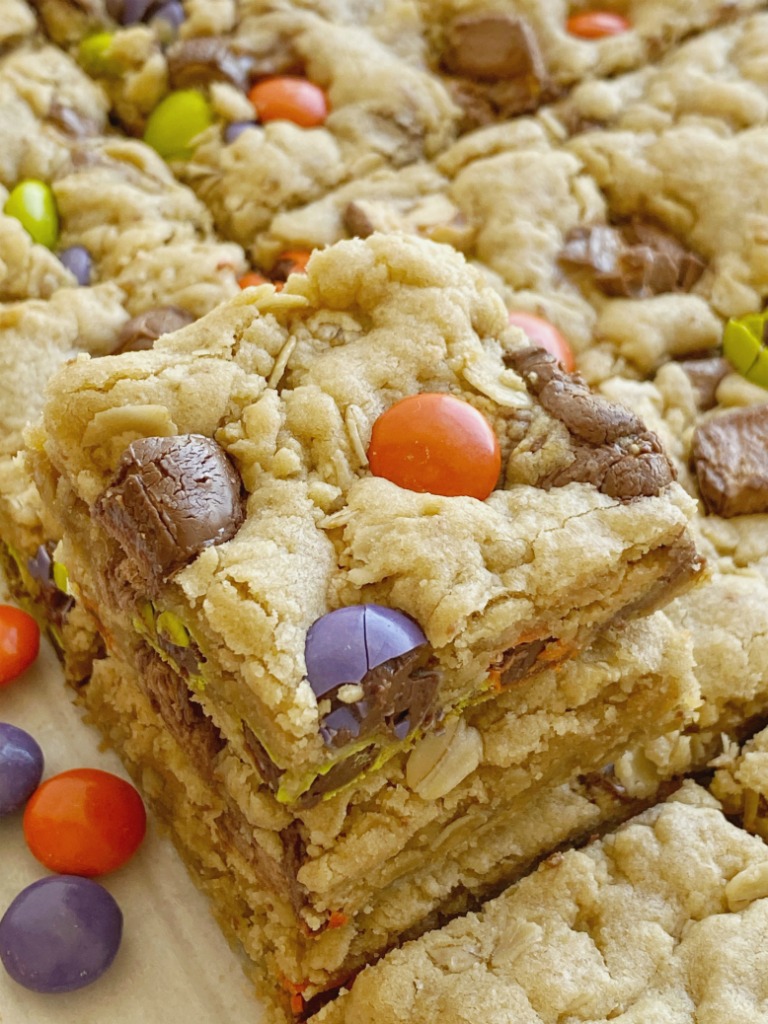 Leftover Halloween Cookie Bars are the best way to use up all that Halloween candy! Soft-baked, thick, chewy, peanut butter oatmeal cookie bars loaded with 2 cups of chopped candy. Kids will love to pick out the candy to put in these bars. 