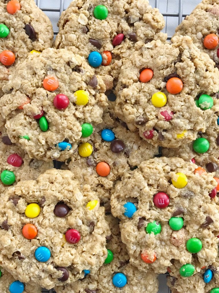 No flour monster cookies are soft-baked and so chewy! Loaded with oats, peanut butter, mini m&m's, and chocolate chips. Perfect cookies for those with a gluten allergy;  just make sure your oats are gluten-free. This cookie recipe freezes perfectly so they're also a great lunch box treat all week | www.togetherasfamily.com #monstercookies #recipe #cookierecipes #glutenfreedesserts #glutenfree #noflourcookies #noflour