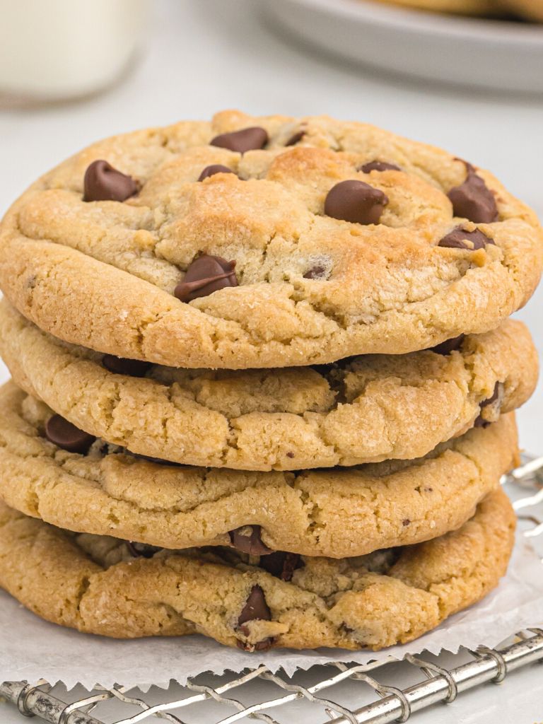 A stack of cookies on parchment paper on top of a wire rack.
