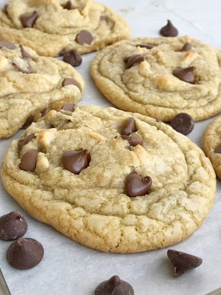 Hands down, these are the best and most perfect chocolate chip cookies! Big, soft-baked centers with buttery and chewy edges. Studded with milk chocolate chips. The secret is in how you shape the dough balls before baking. You MUST TRY this recipe for perfect chocolate chip cookies | www.togetherasfamily.com #cookies #chocolatechipcookies #chocolatechipcookierecipes #chocolate
