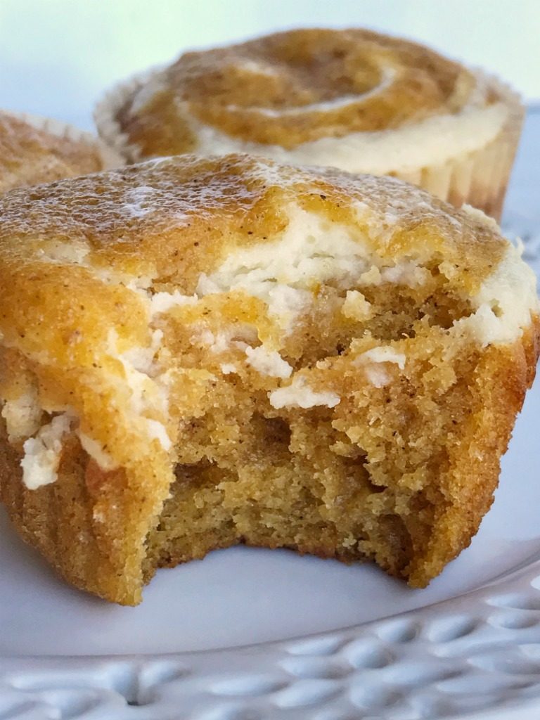 Pumpkin cheesecake muffins combine two of the best flavors for Fall; cheesecake and pumpkin! Moist and soft pumpkin muffins with a cheesecake swirl. These are so soft and tender and taste like pumpkin pie cheesecake. You must try this pumpkin recipe this Fall | www.togetherasfamily.com #pumpkinrecipes #pumpkinmuffins #pumpkinspice #cheesecakerecipes #pumpkincheesecakerecipes