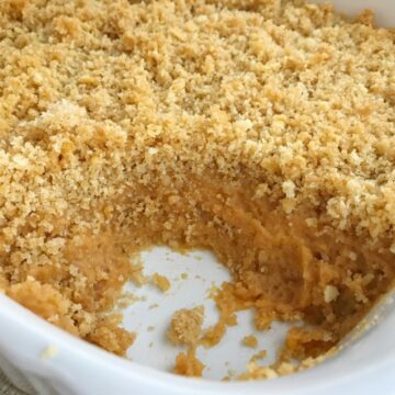 Buttery cracker sweet potato casserole can be on the dinner table in just 30 minutes! No boiling & peeling sweet potatoes. Sweet and creamy sweet potatoes topped with crunchy buttery cracker crumbs. This is such a fun twist to the classic casserole but so much easier. The perfect Thanksgiving side dish | www.togetherasfamily.com #sweetpotatocasserole #casserolerecipes #thanksgivingrecipes