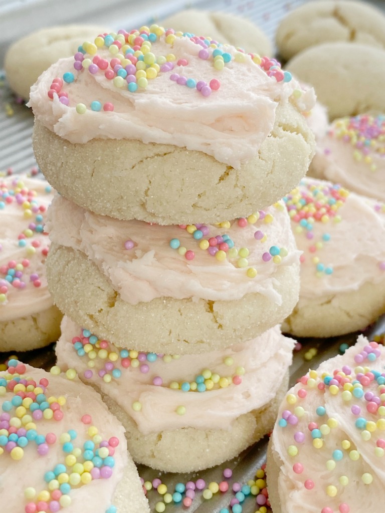 Cake Mix Sugar Cookies are only 5 ingredients, require no rolling and no chilling time, and mix up in just one bowl! Super soft-baked, thick, chewy sugar cookies made so easy with a cake mix. Change up the frosting color and sprinkles for any event or Holiday.