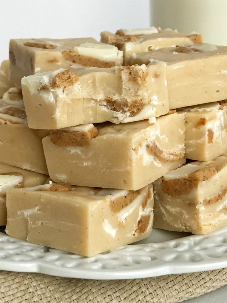 White Chocolate Peanut Butter Reese's Fudge | 4 Ingredients is all you need for this deliciously creamy easy white chocolate peanut butter fudge that's loaded with Reese's! Simple ingredients and only 5 minutes of cook time. It's the perfect treat for Christmas cookie plates. You won't believe how silky smooth this fudge is | www.togetherasfamily.com #fudgerecipes #peanutbutterfudge #christmascookies #reesesrecipes #reesesfudge #whitechocolatefudge #whitechocolatefudge #easyfudgerecipe