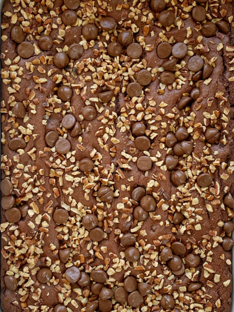 A overhead picture of chocolate and caramel dump cake with pecans on top. 