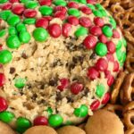 Christmas Cookie Dough Cheeseball Dip | Cookie dough cheeseball dip is the best appetizer or snack to take to a party or munch on during the Holidays! Red and green m&m's cover the outside of a peanut butter oatmeal chocolate chip cookie dough cheese ball. No flour and no eggs so it's perfectly safe to eat. Serve with pretzels, wafers, cookies, and anything else | www.togetherasfamily.com #christmascookies #appetizerrecipes
