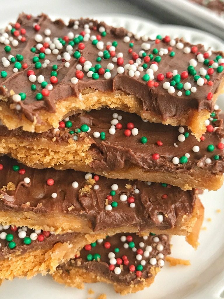 Ritz Cracker Caramel Chocolate Toffee | Crispy, crunchy, sweet and buttery ritz cracker toffee is topped with an easy homemade caramel and milk chocolate chips! Decorate with some Christmas sprinkles and you have a totally addictive Christmas treat. Perfect for sharing, leaving for Santa, or make some goodie plates for the neighbors | www.togetherasfamily.com #christmascookies #toffeerecipes #caramelrecipes #christmasrecipes