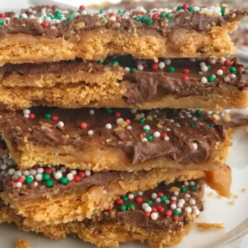 Ritz Cracker Caramel Chocolate Toffee | Crispy, crunchy, sweet and buttery ritz cracker toffee is topped with an easy homemade caramel and milk chocolate chips! Decorate with some Christmas sprinkles and you have a totally addictive Christmas treat. Perfect for sharing, leaving for Santa, or make some goodie plates for the neighbors | www.togetherasfamily.com #christmascookies #toffeerecipes #caramelrecipes #christmasrecipes