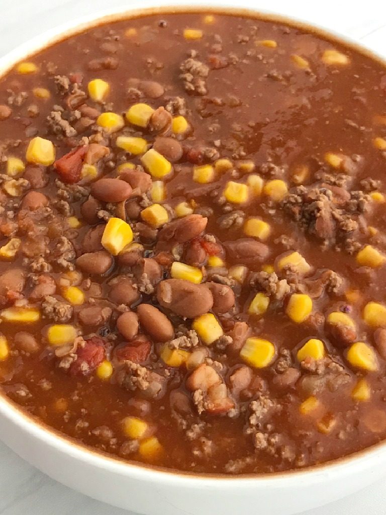 Easy Taco Soup | Easy taco soup is loaded with ground beef, chili beans, corn, and tomatoes. Pile it high with corn chips, sour cream, and shredded cheese. Taco soup is a simple recipe that is so comforting during the cold winter months. One pot and about 30 minutes is all you need for an easy dinner! | Together as Family #tacosoup #tacosouprecipes #souprecipes #easyrecipes