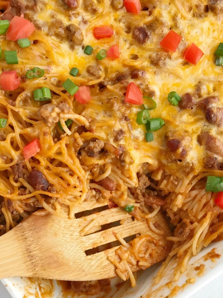 Cheesy taco spaghetti casserole is the ultimate dinner comfort food. Cheesy pasta loaded with taco seasoned ground beef, chili beans, and tomato. Bakes in one pan, serves a crowd, and the leftovers are fabulous for another meal! Together as Family #casserolerecipes #dinnerrecipes #recipeoftheday #casseroles #casserolerecipe