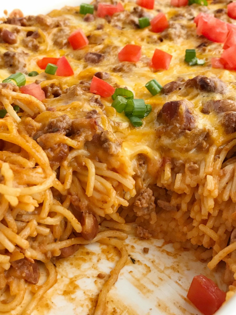 Cheesy taco spaghetti casserole is the ultimate dinner comfort food. Cheesy pasta loaded with taco seasoned ground beef, chili beans, and tomato. Bakes in one pan, serves a crowd, and the leftovers are fabulous for another meal! Together as Family #casserolerecipes #dinnerrecipes #recipeoftheday #casseroles #casserolerecipe