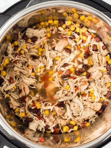 A instant pot with Santa Fe chicken burrito mixture. Inside the insert of the instant pot.