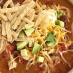 Chicken Tortilla Soup Recipe | The best 5 ingredient chicken tortilla soup only takes 20 minutes to make! One pot is all you need for this delicious and creamy tortilla soup. Combine 5 ingredients + some spices and let it simmer on the stove top. Top with cheese, avocado, chips, and sour cream.