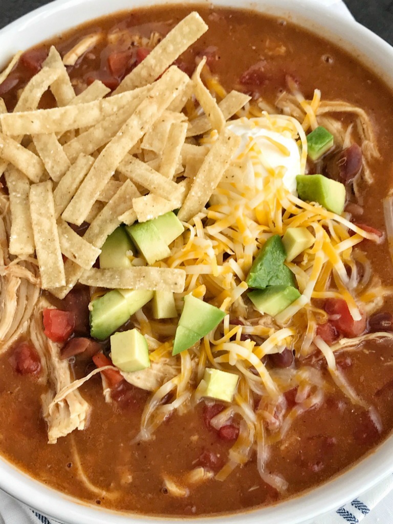 Chicken Tortilla Soup Recipe | The best 5 ingredient chicken tortilla soup only takes 20 minutes to make! One pot is all you need for this delicious and creamy tortilla soup. Combine 5 ingredients + some spices and let it simmer on the stove top. Top with cheese, avocado, chips, and sour cream.