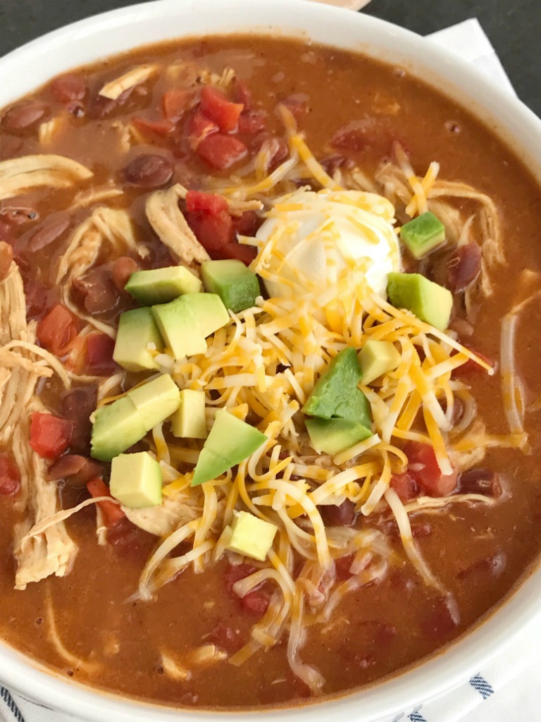 Chicken Tortilla Soup Recipe | The best 5 ingredient chicken tortilla soup only takes 20 minutes to make! One pot is all you need for this delicious and creamy tortilla soup. Combine 5 ingredients + some spices and let it simmer on the stove top. Top with cheese, avocado, chips, and sour cream.