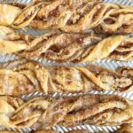 Maple Pecan Crescent Cinnamon Twists | These quick & easy 20 minute maple pecan cinnamon twists are made with refrigerated crescent dough and are perfect for brunch, a snack, and even a sweet breakfast treat. Buttery crescent dough filled with a pecan cinnamon mixture and baked to perfection! Top with a simple maple and powdered sugar glaze and enjoy!