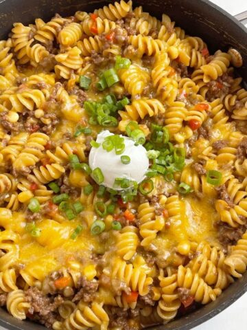 BBQ beef skillet dinner recipe with ground beef, pasta, corn, and beef broth.