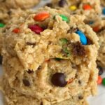 Cake Mix Monster Cookies | Cake mix monster cookies are an easy and fun twist to the classic monster cookie. A yellow cake mix, peanut butter, oats, chocolate chips, and m&m's create a thick, soft-baked, and chewy cake mix monster cookies that are so easy to make #cookierecipes #monstercookierecipes #cookies #peanutbuttercookies