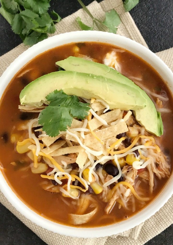 Instant Pot Chicken Tortilla Soup | Healthy chicken tortilla soup made right in an instant pot! It's practically dump n' go and loaded with tender chicken, black beans, tomato, corn, and simmers in the pressure cooker, instant pot, or express cooker. Top with tortilla strips, cheese, and avocado for a healthy and easy dinner | Together as Family #instantpotrecipes #instantpot #pressurecookerrecipes #souprecipes #easydinnerrecipes