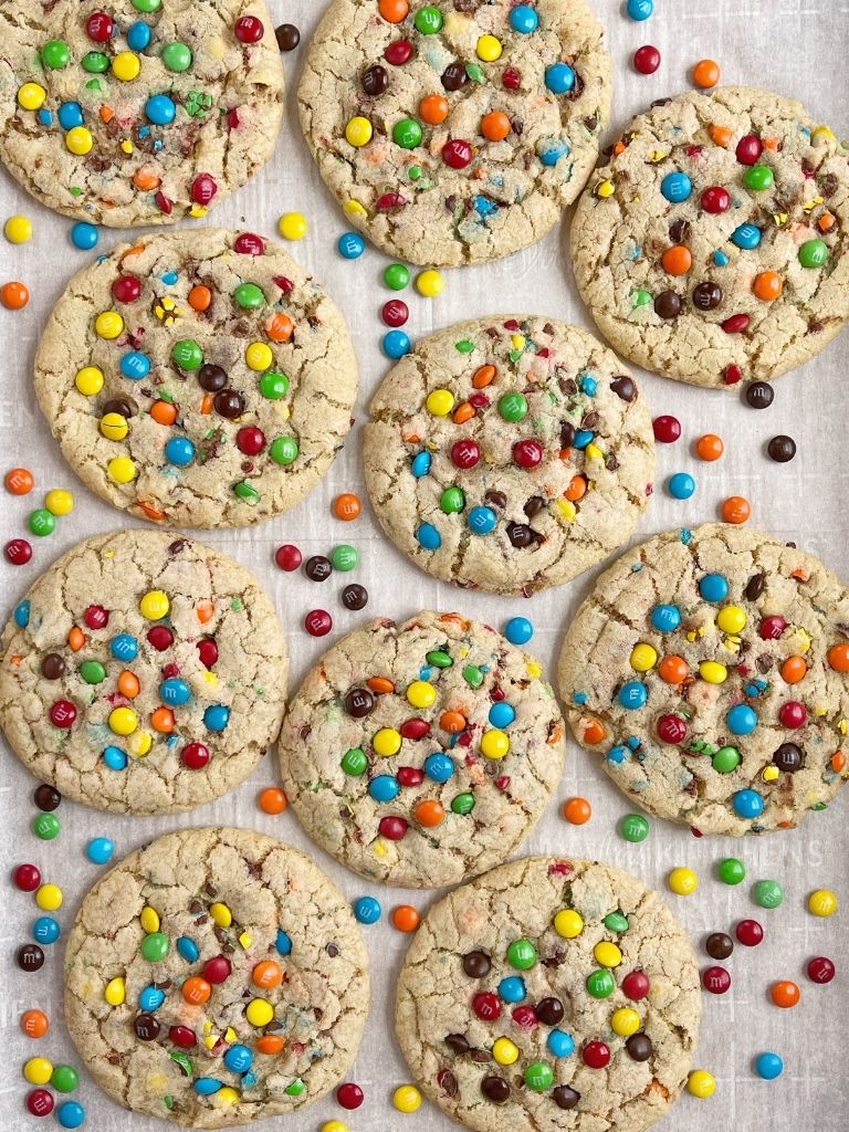 An overhead shot of m&m cookies on a cookie sheet.