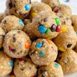 Monster cookie energy balls with only 6 ingredients like oats, peanut butter, honey, chocolate chips, and m&m.