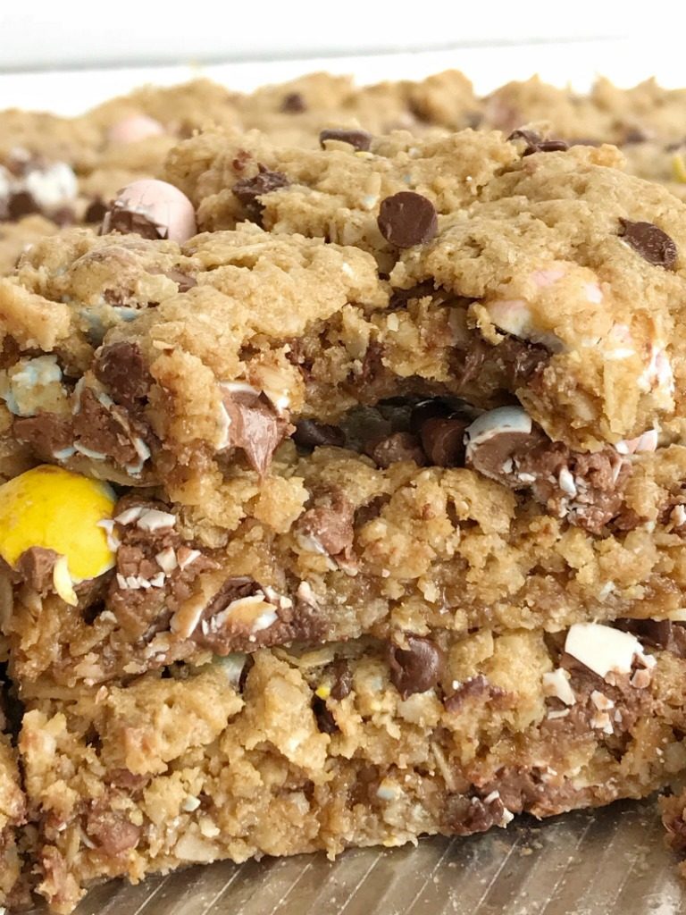 {no flour, gluten-free} Mini Cadbury Egg Cookie Bars | No flour mini Cadbury egg cookie bars are the best way to celebrate Easter! These gluten-free, no flour cookie bars are loaded with oats, peanut butter, chocolate, and an entire bag of mini Cadbury eggs. You must try this easy dessert that's made in a cookie sheet so it's perfect for a crowd or for freezing | #easyrecipes #easter #easterrecipes #easterdessertrecipes #cadburyeggs 