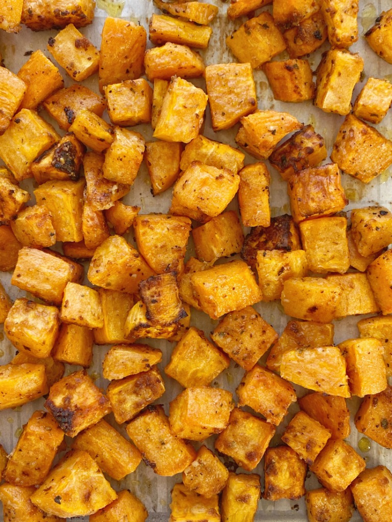 Roasted Garlic Parmesan Sweet Potatoes are roasted in butter, olive oil, parmesan cheese, and seasonings. A crispy charred outside with a soft sweet potato center. One bowl and a few simple ingredients are all you need for this delicious side dish recipe.