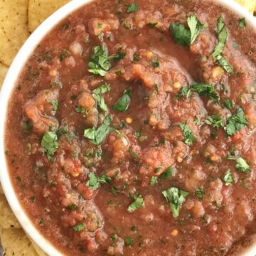 Homemade Blender Salsa | Homemade Salsa | Appetizer | Mexican Food | 10 Minutes | Quick and Easy | This 10 minute homemade blender salsa is so simple & yummy that you will never buy salsa again! Canned whole tomatoes, cilantro, onion, jalapeno, garlic, lime, and seasonings combine for an easy homemade salsa that's made in the blender in only 10 minutes. Serve with chips for an appetizer/snack or use in any recipe that calls for salsa. #easyrecipes #homemade