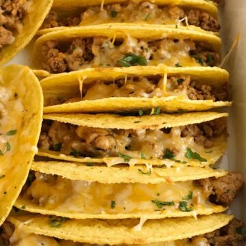 Baked Ground Chicken Tacos | Tacos | Mexican recipes | recipes with ground chicken | Baked ground chicken tacos are an easy, 30 minute dinner recipe! Crispy corn taco shells are filled with tender and flavorful ground chicken with homemade taco seasoning. So much flavor and healthy too! Load up the cheesy crispy tacos with all your favorite toppings #tacos #easydinnerrecipes #dinner #groundchicken #mexicanfood