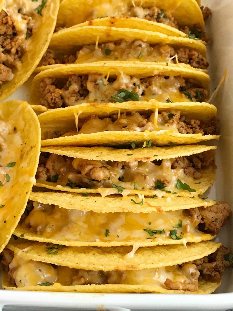 Baked Ground Chicken Tacos | Tacos | Mexican recipes | recipes with ground chicken | Baked ground chicken tacos are an easy, 30 minute dinner recipe! Crispy corn taco shells are filled with tender and flavorful ground chicken with homemade taco seasoning. So much flavor and healthy too! Load up the cheesy crispy tacos with all your favorite toppings #tacos #easydinnerrecipes #dinner #groundchicken #mexicanfood