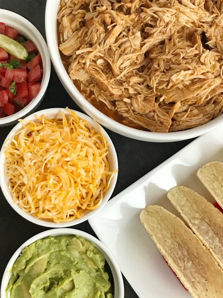 Slow Cooker Enchilada Chicken Tacos | Slow Cooker | Crock pot | Chicken Tacos | Shredded Chicken Recipes | Enchilada chicken tacos are made in the slow cooker (or crock pot) and only require 5 ingredients! Chicken breasts, red and green enchilada sauce, taco seasoning, and green chilies. The shredded enchilada chicken is so tender and tastes like enchiladas. It makes the perfect filling for tacos, soft tacos, burritos, enchiladas, or a taco rice bowl! #chickenrecipes #crockpot #slowcookerrecipes #mexicanfood #easydinnerrecipes