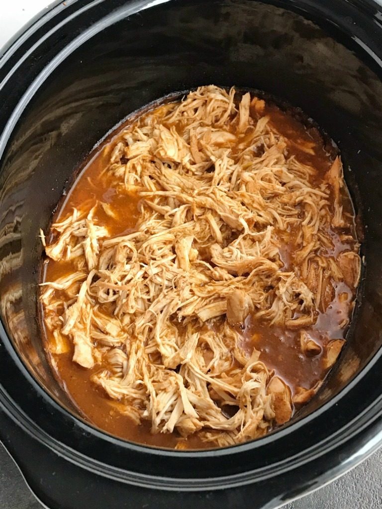 Slow Cooker Enchilada Chicken Tacos | Slow Cooker | Crock pot | Chicken Tacos | Shredded Chicken Recipes | Enchilada chicken tacos are made in the slow cooker (or crock pot) and only require 5 ingredients! Chicken breasts, red and green enchilada sauce, taco seasoning, and green chilies. The shredded enchilada chicken is so tender and tastes like enchiladas. It makes the perfect filling for tacos, soft tacos, burritos, enchiladas, or a taco rice bowl! #chickenrecipes #crockpot #slowcookerrecipes #mexicanfood #easydinnerrecipes